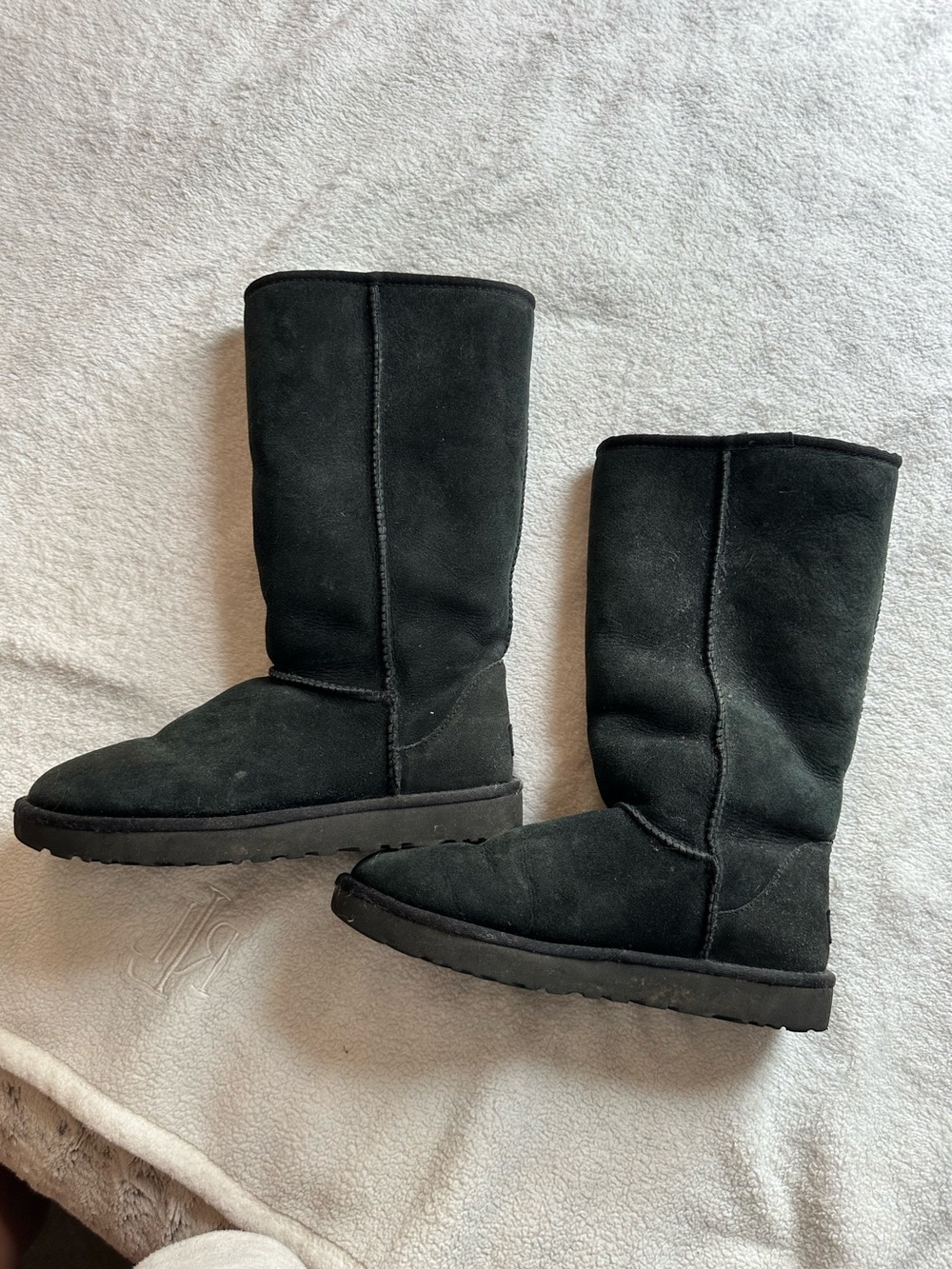 Tall black UGG boots